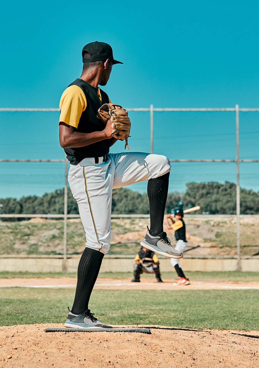 Youth baseball player in action during a game, focusing on travel sports and team spirit.