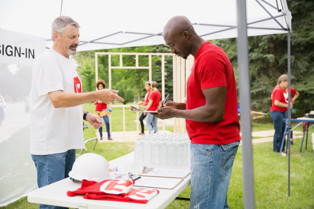 Custom printed T-shirts at outdoor promotional event for brand visibility.